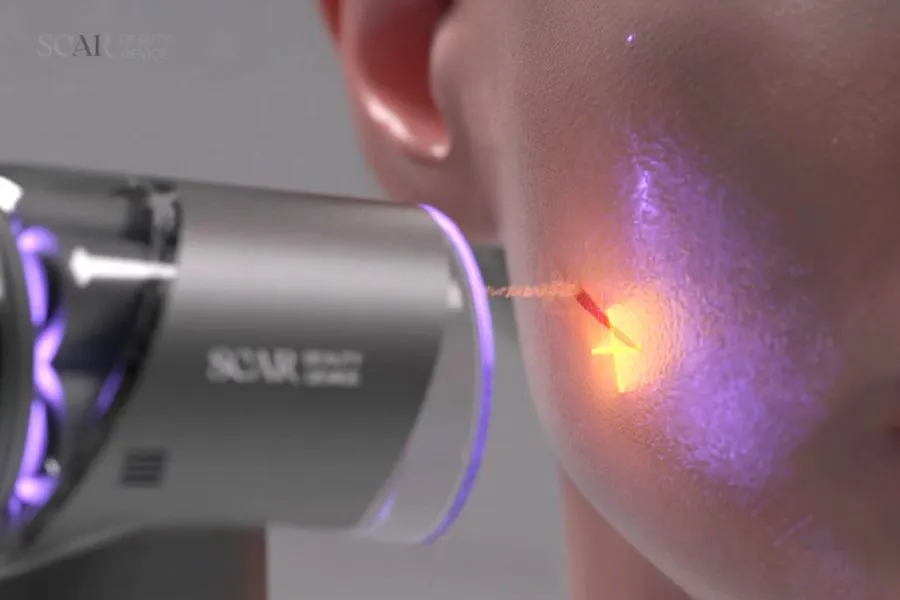 A woman using an electronic device against her skin